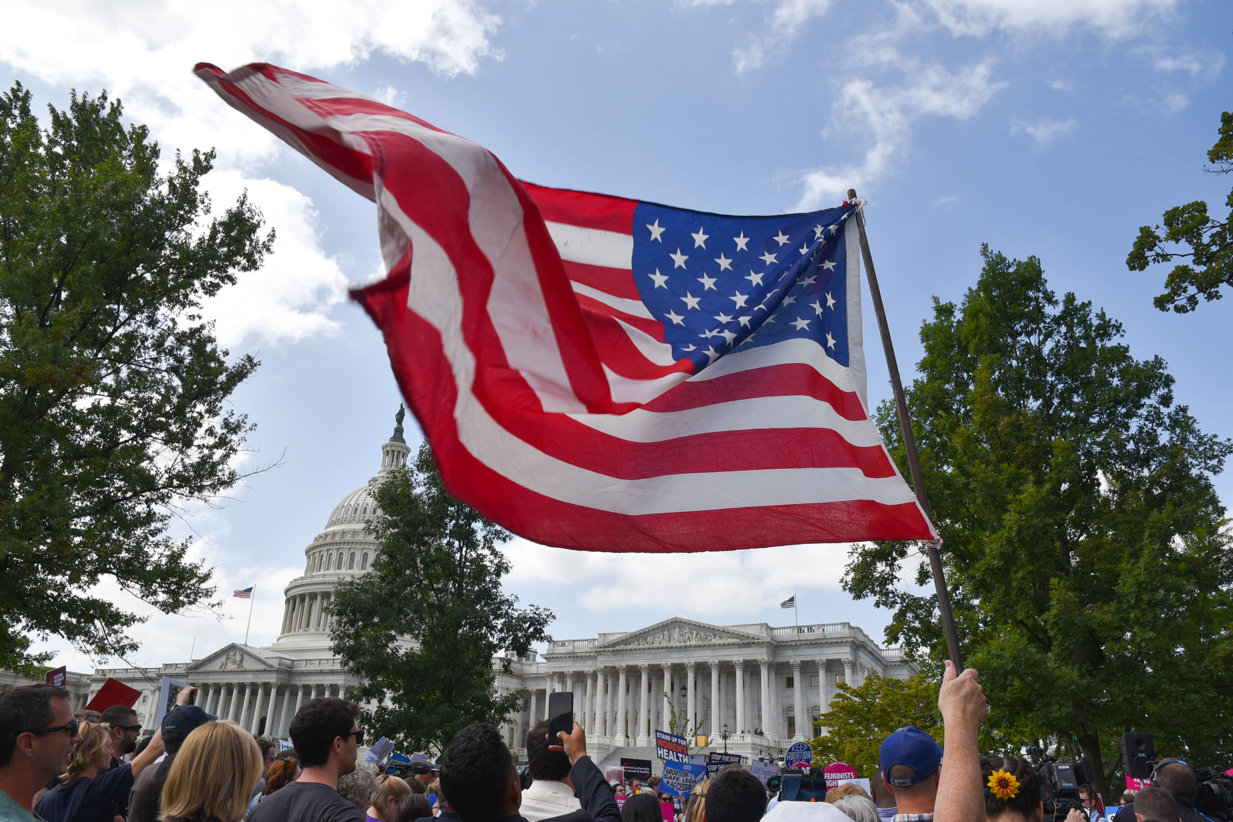 A protester waves an American flag in the breeze outside the U.S. Capitol